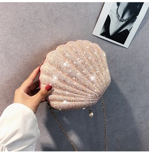 Detail of champagne gold sequin shell bag with large pearl clasp and golden chain