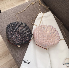 Detail of shell-shaped sequin bags with golden chains and white pearl accents