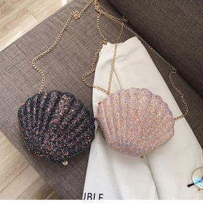 Close-up of sequined shell crossbody bags with gold chains and pearl accents