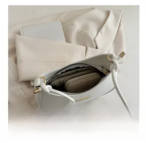 Top view of white saddle bag interior showing storage space for phone and wallet