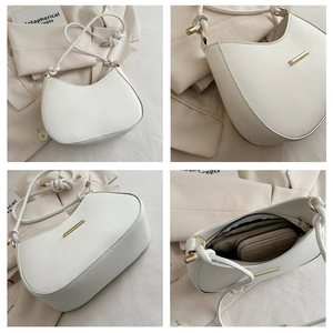 White crescent shoulder bag detail with gold hardware and spacious interior view