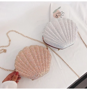 Close-up of shell-shaped sequin crossbody bags with gold chain straps and pearl clasps
