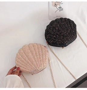 Detail of glittery shell-shaped cross-body bags in black and champagne with gold chains