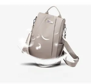 Close-up of lightweight nylon backpack featuring elegant pleated details and metal logo plate