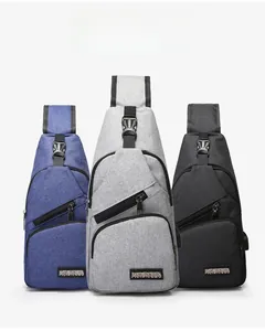 Three men's compact sling bags in navy, grey, and black featuring external USB ports
