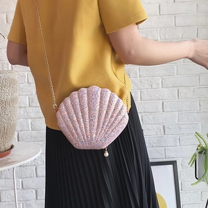 Sweet pink sequin shell crossbody bag with gold chain strap and pearl charm detail