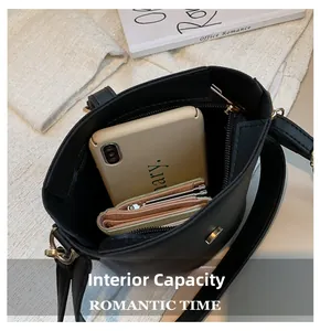 Interior view of black bucket bag showing spacious capacity for phone and wallet