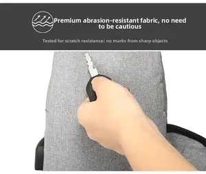 Detail of gray oxford chest bag showing scratch-resistant fabric and USB port