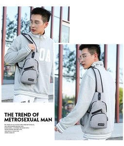 Outdoor lifestyle shot of a gray casual chest bag showing adjustable strap and buckle