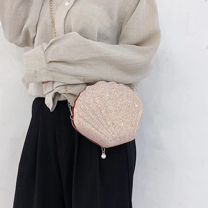 Sparkly sequin shell-shaped crossbody bag with gold chain strap and pearl pendant