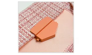 Detail of pink tweed and leather crossbody bag with modern geometric matte buckle