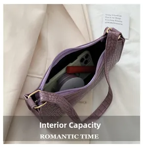 Interior view of purple crocodile texture baguette bag with phone and cosmetics