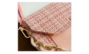 Detailed shot of pink tweed texture with decorative resin chain and metal hook
