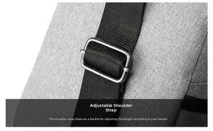 Detail of adjustable black nylon shoulder strap with a silver metal buckle on gray bag