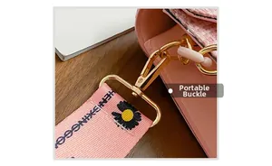 Detail of pink tweed bag featuring golden metal clasp and daisy floral print wide strap