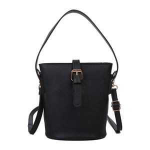 Minimalist black leather bucket bag with gold metal buckle and adjustable shoulder strap