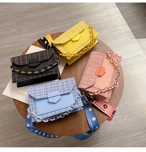 Detail of four colorful tweed crossbody bags with acrylic chains and daisy print straps