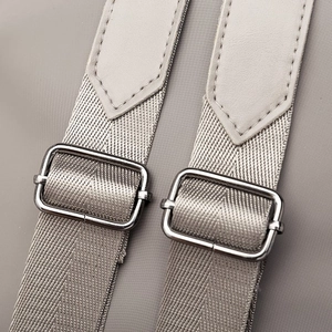 Adjustable nylon shoulder straps with silver metal buckles on a gray waterproof backpack