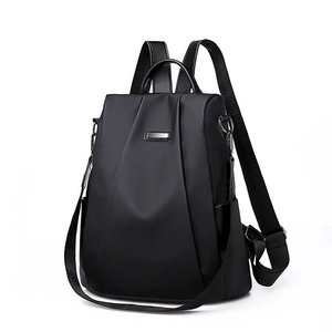 Waterproof black nylon backpack with multi-way straps and polished metal logo plate