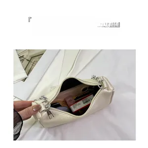 Internal view of the cream white shoulder bag showing large capacity for daily essentials