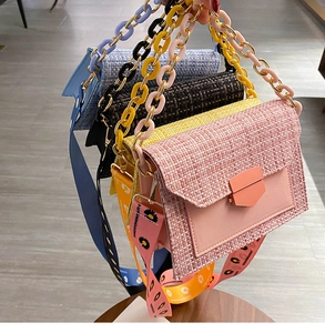 Detail of tweed crossbody bags with chunky acrylic chain and daisy print wide strap