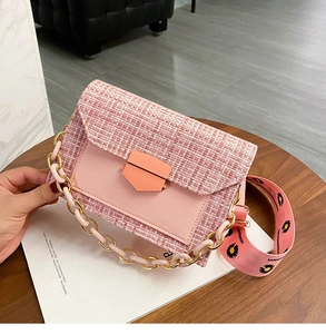 Pink tweed crossbody bag featuring a wide printed strap and chic metal chain detail