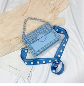 Blue tweed crossbody bag with floral strap and chunky chain detail shown from above