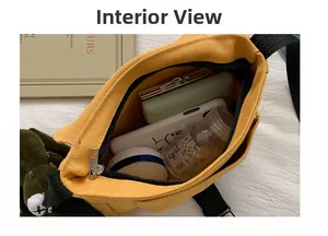 Interior view of yellow canvas messenger bag showing storage for phone and accessories