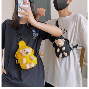 Detailed view of canvas chest bags with cute plush bear charms in yellow and black colors