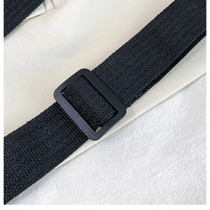 Macro shot of durable black nylon strap with matte adjustable slide buckle on canvas bag