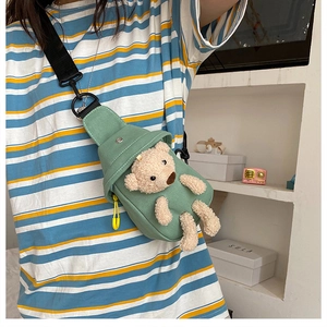 Light green canvas chest bag with a cute 3D plush bear on a striped shirt model