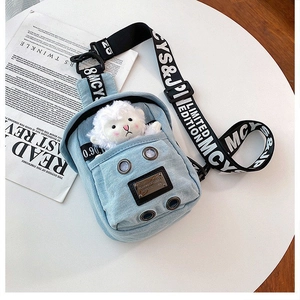 Detail of blue denim crossbody bag featuring cute plush sheep and trendy printed strap