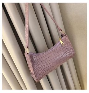Detail of light purple crocodile embossed texture on a chic rectangular baguette bag