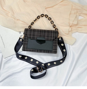 Detail of tweed flap handbag featuring a daisy print wide strap and chunky gold chain handle