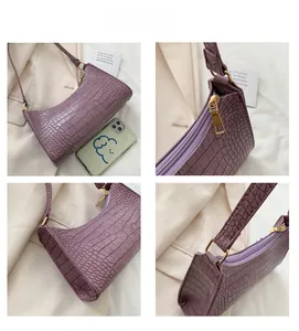 Detail shots of purple crocodile texture handbag with gold zipper and metal buckles