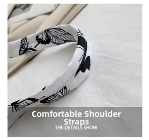Detail of comfortable shoulder strap with black butterfly print on white woven fabric