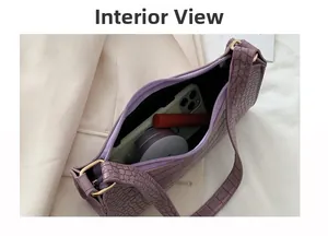 Interior display of a purple baguette bag showing spacious storage for daily essentials