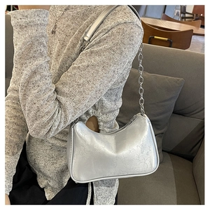 Silver crescent underarm bag with vintage texture and stylish metal chain strap detail