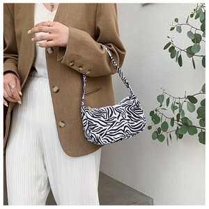 Zebra print canvas hobo bag styled with a brown blazer and white trousers