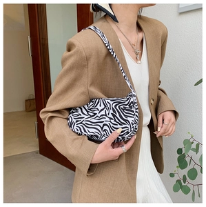 Close-up of zebra pattern canvas underarm bag with black and white animal print