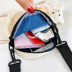 Internal view of the cream canvas crossbody bag showing spacious storage for essentials