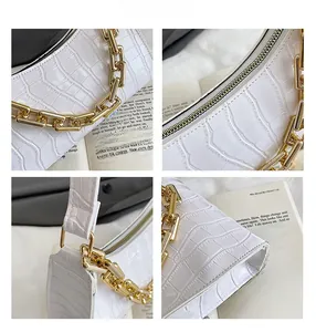 Detailed views of white crocodile pattern leather bag with chunky gold metal chain strap