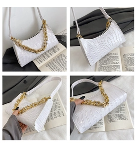 Detail shots of white crocodile pattern shoulder bag with a bold gold chain and slim strap
