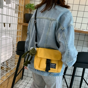 Japanese style yellow canvas messenger bag with adjustable strap and frog pendant