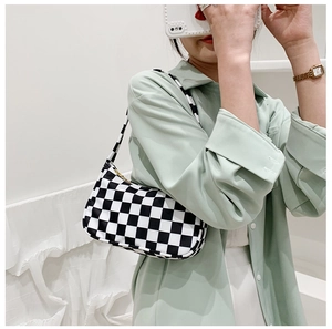 Fashionable black and white checkerboard canvas shoulder bag worn under the arm style