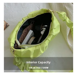 Interior capacity of fluorescent green pleated cloud bag showing storage space