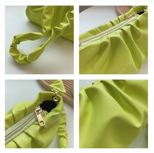 Detail view of lime green pleated leather texture and gold-tone zipper on cloud bag