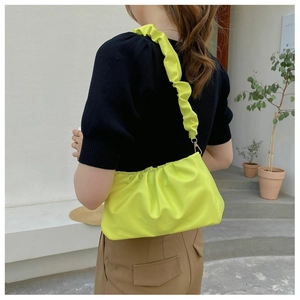 Detail of neon green ruched cloud bag showing the pleated ruffles on the shoulder strap