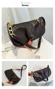 Detailed view of brown ruched cloud bag with chunky gold chain and smooth PU leather
