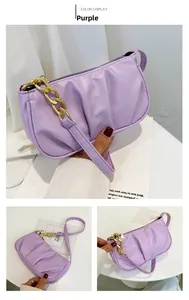 Detail view of purple ruched shoulder bag with chunky gold chain strap decoration